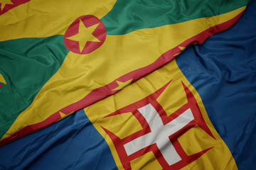 waving colorful flag of madeira and national flag of grenada.