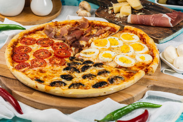 Italian Four Seasons Pizza (Pizza Quattro Stagioni). Proschutto, mushroom, cherry tomato, egg.
