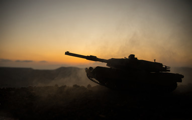 War Concept. Armored vehicle silhouette fighting scene on war fog sky background. American tank at...