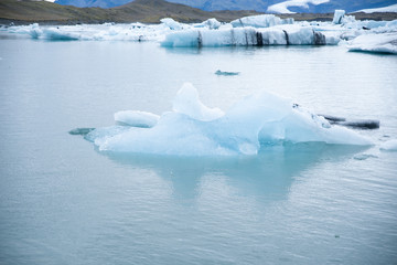 Fototapeta na wymiar Icebergs in the Jökulsárlón glacier lake in Iceland in winter. Photographed at cloud.