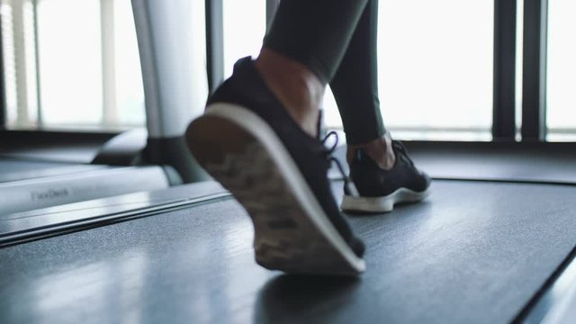 Young Fit Woman Walking on Treadmill in Gym. Cardio Training Weight Loss Concept. 4K Slowmotion Footage.