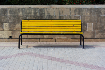 Yellow bench on sunny day