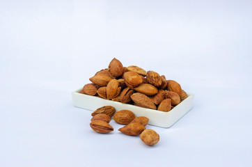 Bowl of almonds isolated on white background