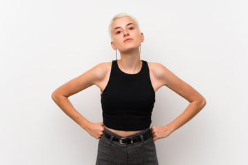 Teenager girl with short hair over white wall angry