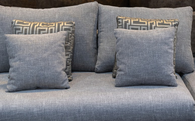 Modern brown fabric pillows with gold checkered pattern pillows on brown fabric cushion sofa interior decoration