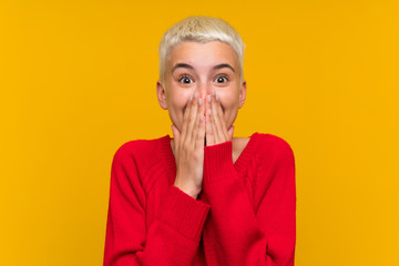 Teenager girl with white short hair over yellow wall with surprise facial expression - obrazy, fototapety, plakaty
