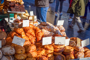 Variety of artisan pastries and breads for sale at a street market stall in the UK - Powered by Adobe