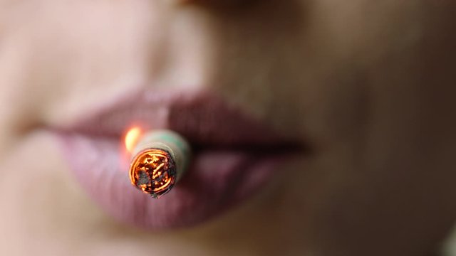 Women light and poof cigarette, close up macro, prores4444, RAW, Arri Alexa mini