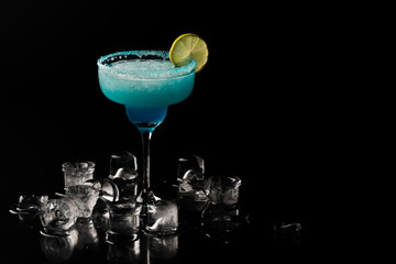 Blue alcoholic cocktail in a black background