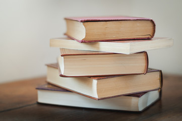 A pile of books on a table.