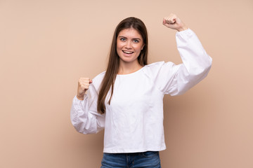 Young girl over isolated background celebrating a victory