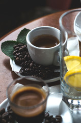 Cup of coffee and limonade on wooden table.