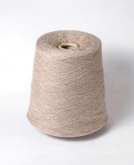 bobbin of yarn on a white background. Side view.Textile reel on isolated white background.