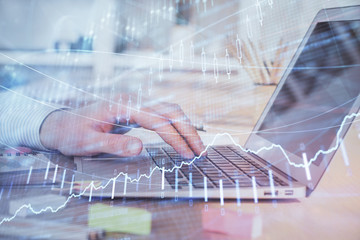 Double exposure of stock market graph with man working on laptop on background. Concept of financial analysis.