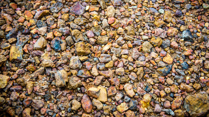 Close up rough small red rocks or road pebbles. Top view. Used to pave the way.