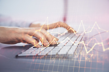 Forex graph with businessman working on computer in office on background. Concept of hardworking....