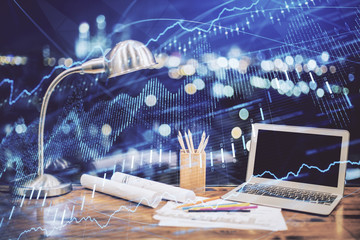 Financial chart drawing and table with computer on background. Multi exposure. Concept of international markets.