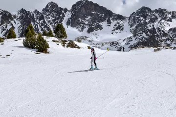 Fotobehang Skier going downhill in slope in popular ski resort Pas de La Casa in Andorra, Pyrenees mountains -Image © DBER