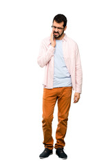 Fototapeta premium Full-length shot of Handsome man with beard with toothache over isolated white background