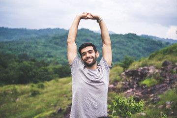 Portrait of young handsome man happy and smiling,Travel at outdoor,Hand raise up