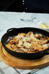 Cheese pan with tomatoes and sweet pepper and fried onions sprinkled with cheese