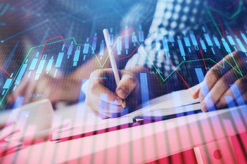 Multi exposure of two men planing investment with stock market forex chart.