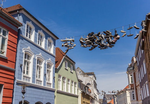 Old shoes on a rope between houses in Flensburg, Germany