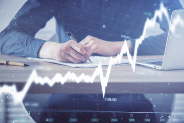 Double exposure hands with stock market chart.