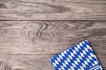 Folded bavarian napkin on a wooden table with copy space, top view. Food background