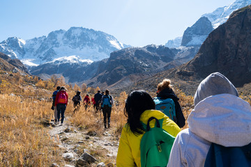 A team of tourists goes to the rocky mountains.