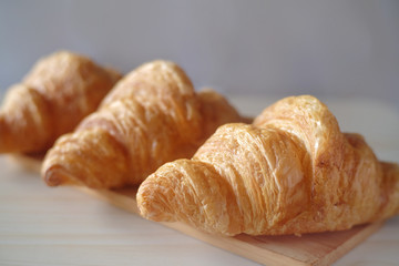 Close up Fresh croissant on wood table. Tasty buttery croissants.