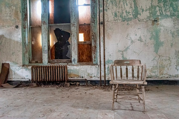 USA, New York, Ellis Island - May 2019: Old furniture abandoned in a derelict building