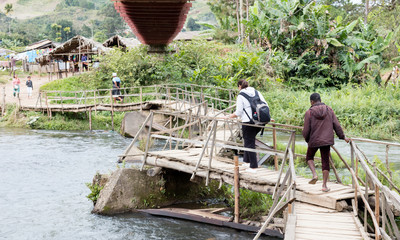 Ranomafana, Madagascar on july 28, 2019 - Instable old wooden bridge over a river, roadway for the local people on Ranomafana, Madagascar