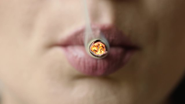 young women lips Smoking of joint, cigarette, close up macro, prores4444, RAW, Arri Alexa mini