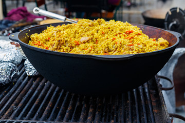 Cooking of pilaf with meat and spices