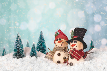 Two Snowmen in a Holiday Winter Scene