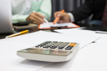 Business man Writing expense information in home office.team work concept