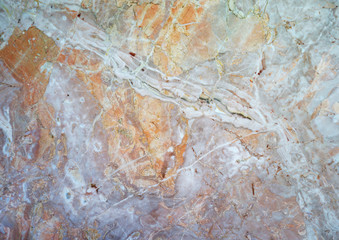 polished light orange veined stone surface, photo