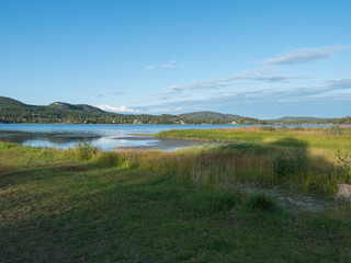 Vew on Sjalevadsfjarden lake in ornskoldsvik city in Vasternorrland region of Sweden. Summer sunny day, blue sky background