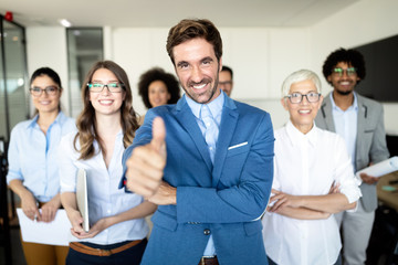 Happy business people celebrating success at company