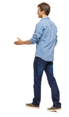 Back view of a walking businessman who stretches his hand for a
