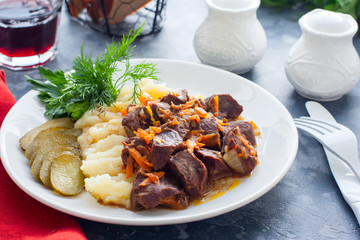 Braised beef heart with mashed potatoes and pickles, horizontal