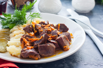 Braised beef heart with mashed potatoes and pickles, horizontal
