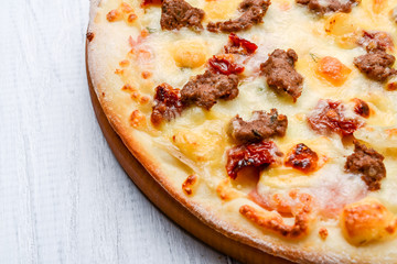 Minced meat tomato red onion pizza on a wood background. toning