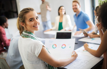 Team of colleagues brainstorming together while working in modern office