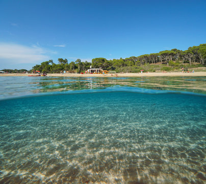 Spain Mediterranean beach in summer and sand underwater sea, split view over and under water surface, Costa Brava, Catalonia, Palamos, Playa El Castell