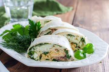 Lavash roll with canned saury, cheese and eggs, selective focus © Анна Журавлева