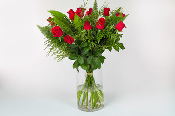 Bouquet of red roses in vase isolated on white.