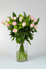 Bouquet of pink roses in vase isolated on white.