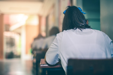 Asian high school students in a white school uniform are serious and tired of exams.